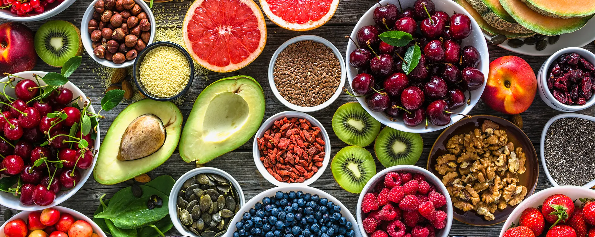 Selection of healthy food. Superfoods, various fruits and assorted berries, nuts and seeds. 